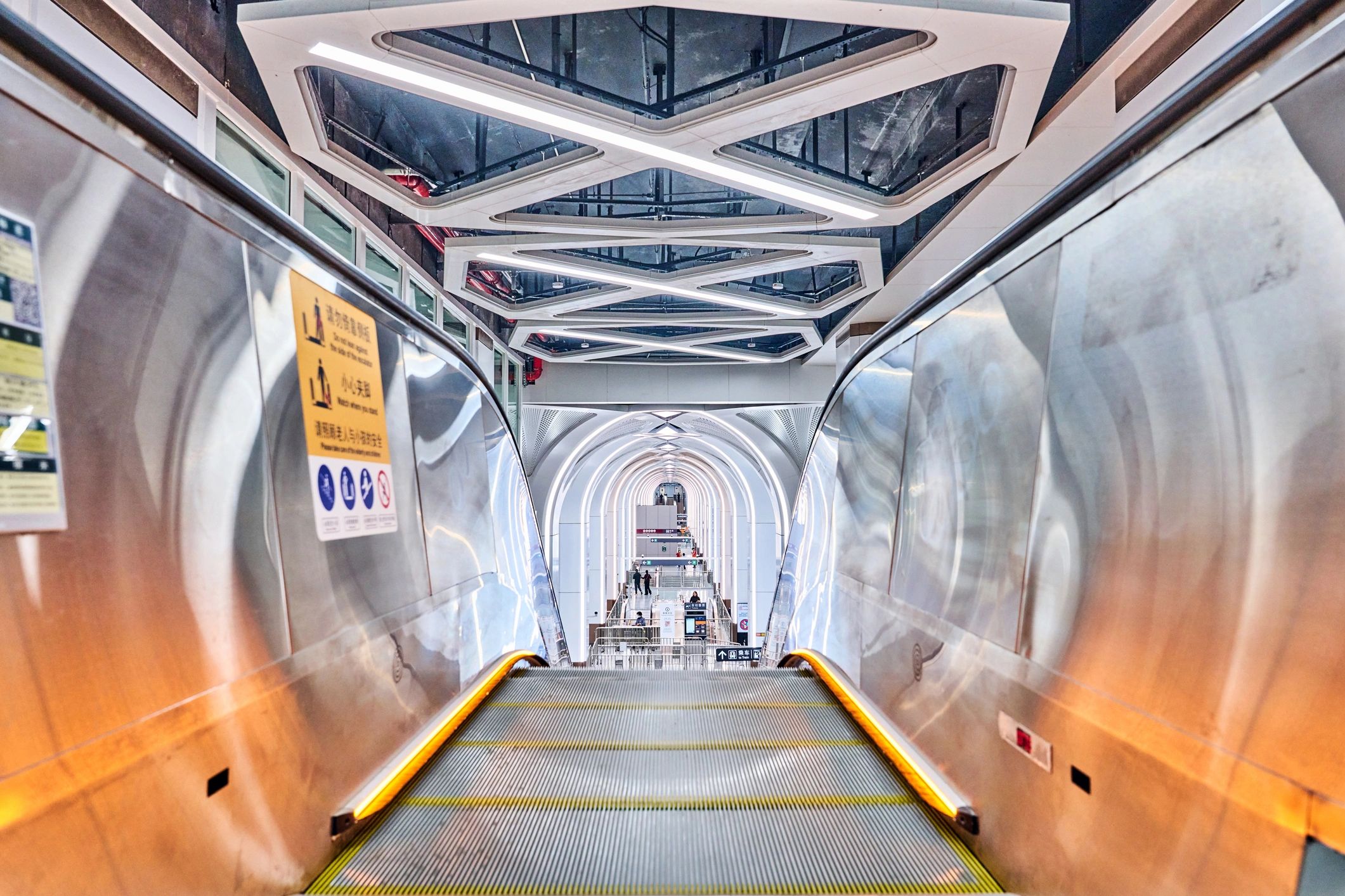 Black-and-white escalator in an industrial modern transit station