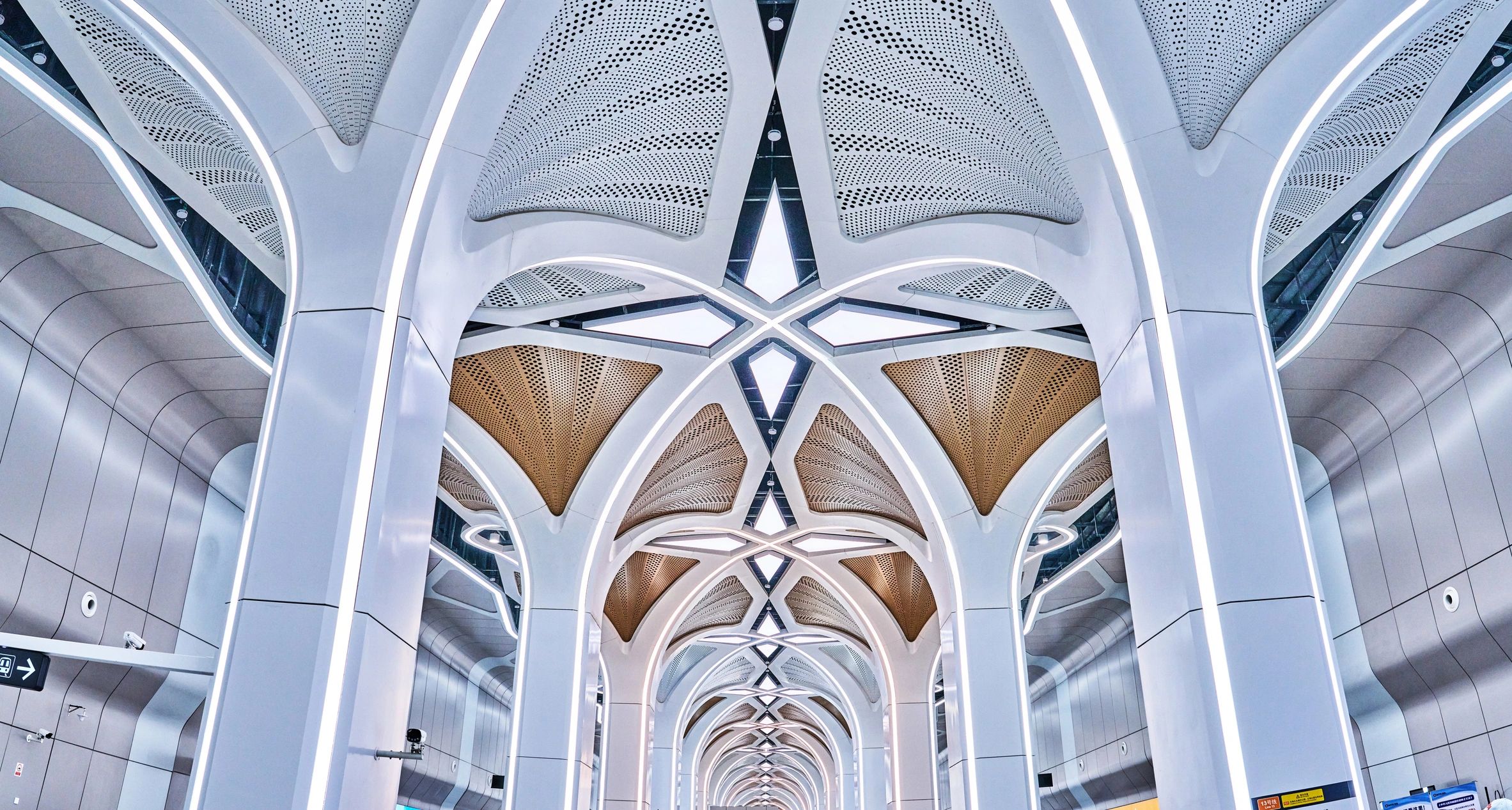 Black-and-white escalator and structural lines in an industrial-modern station